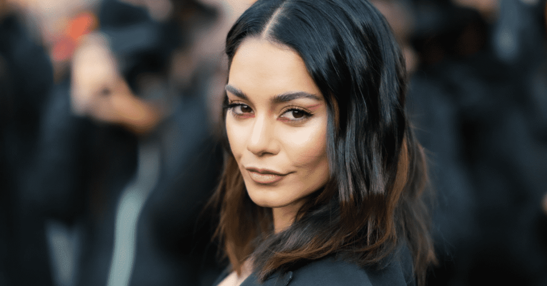 Vanessa Hudgens on the red carpet smiling at fans